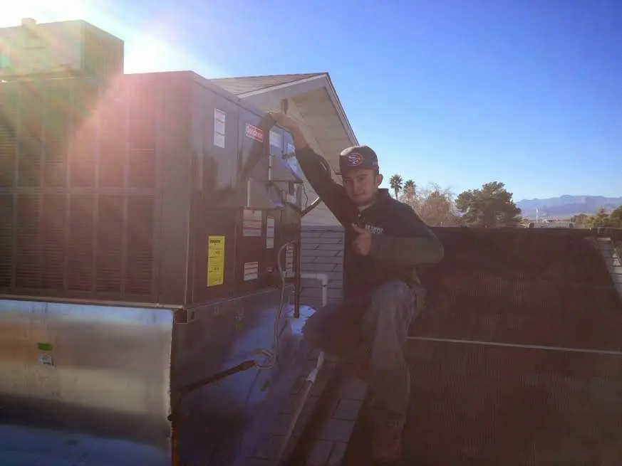 HVAC technician performing HVAC Inspection on a rooftop unit in Glenolden